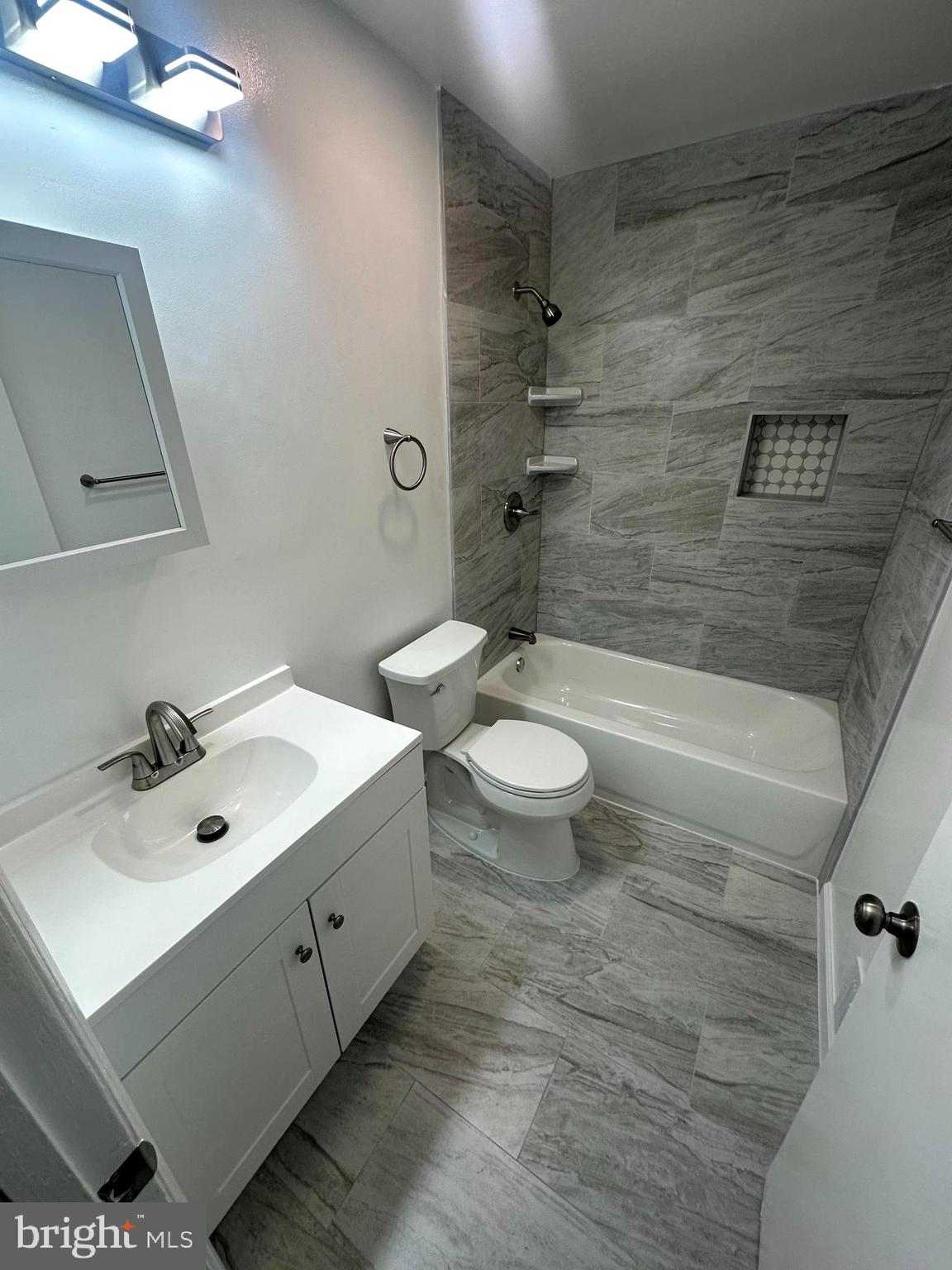 3912 21st Avenue Temple Hills, MD 20748 - Photo 16 of 36 a bathroom with a sink mirror toilet and bathtub