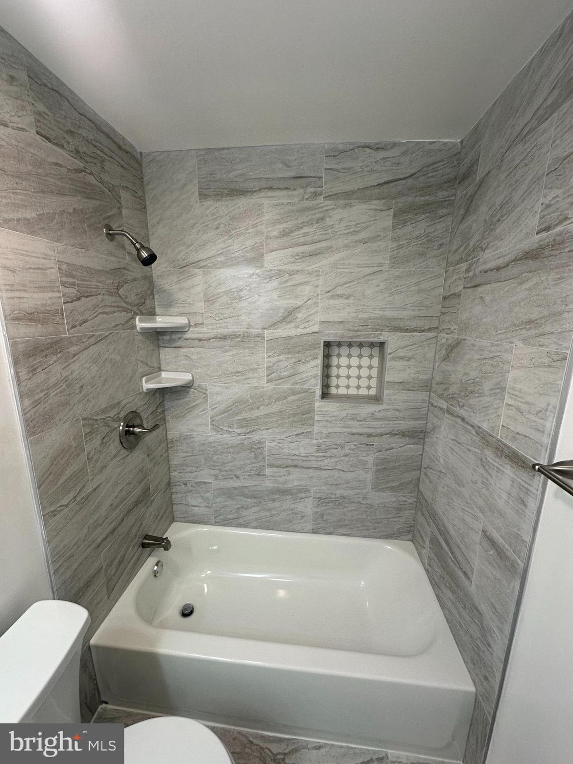 3912 21st Avenue Temple Hills, MD 20748 - Photo 17 of 36 a bathroom with a bathtub and a toilet