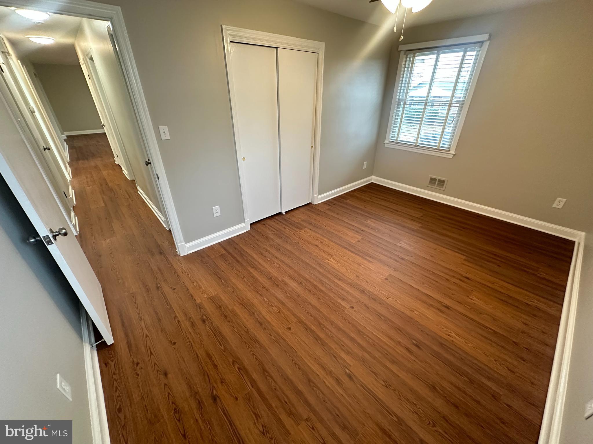 3912 21st Avenue Temple Hills, MD 20748 - Photo 19 of 36 a view of an empty room with wooden floor and a window