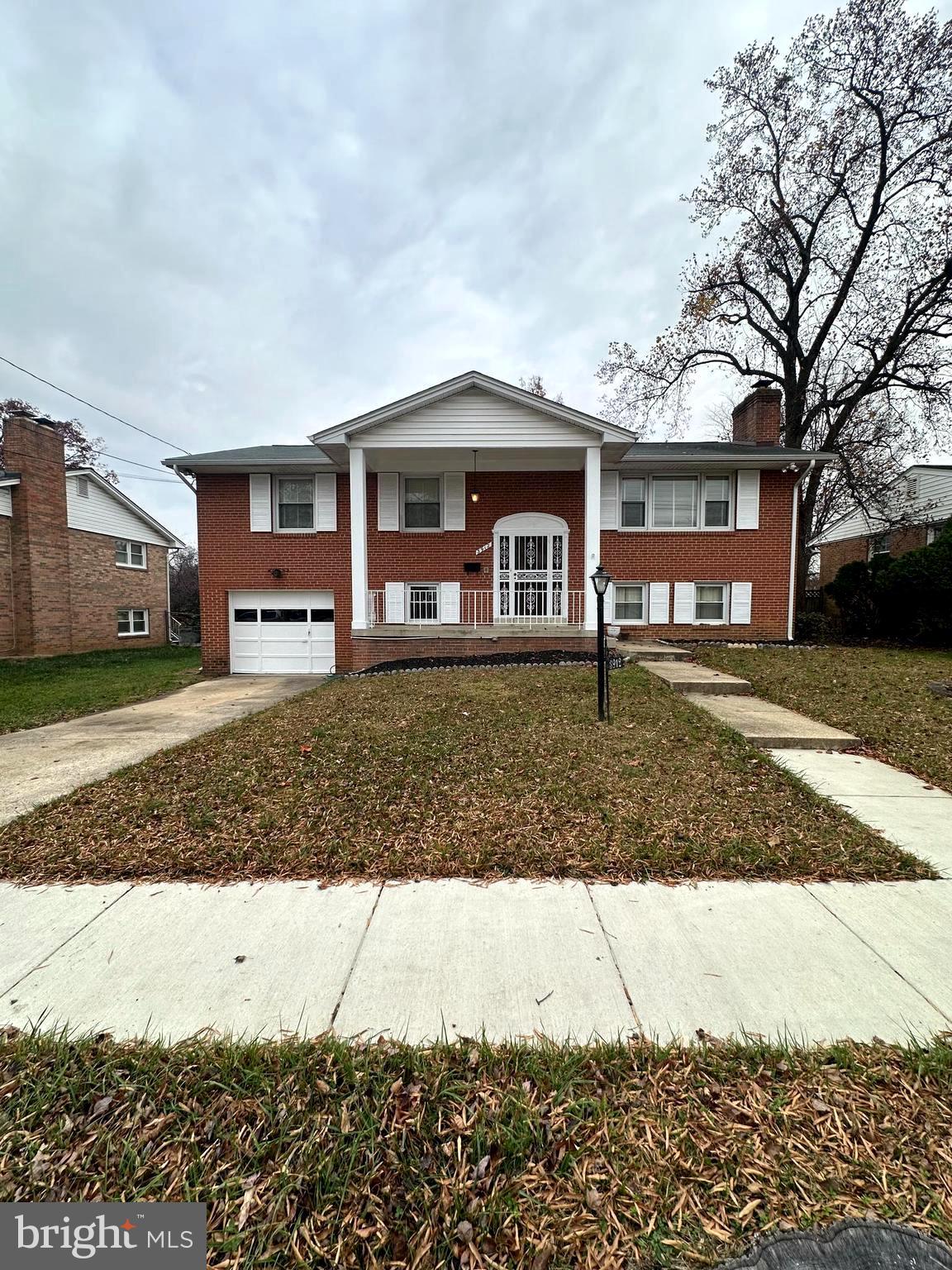 3912 21st Avenue Temple Hills, MD 20748 - Photo 2 of 36 a front view of a house with a yard
