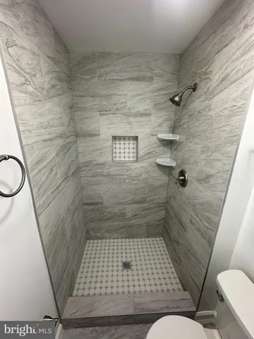 a white toilet sitting next to a bathroom sink