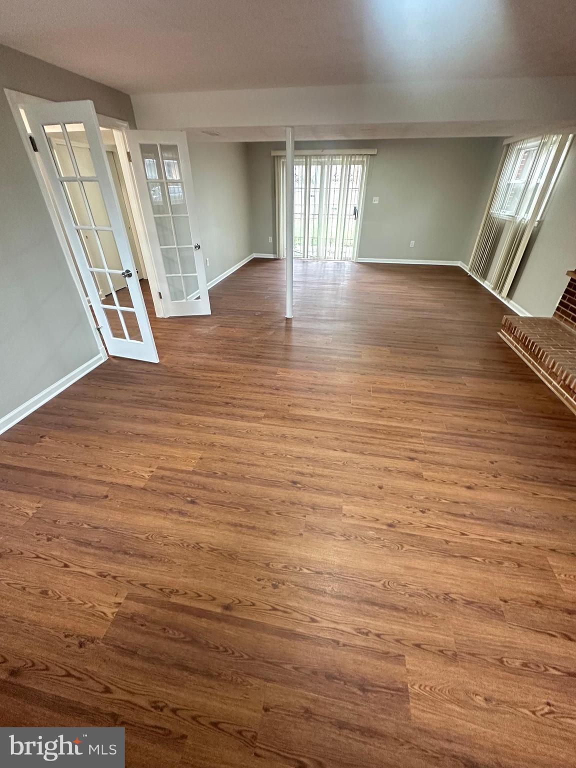 3912 21st Avenue Temple Hills, MD 20748 - Photo 26 of 36 an empty room with wooden floor and windows