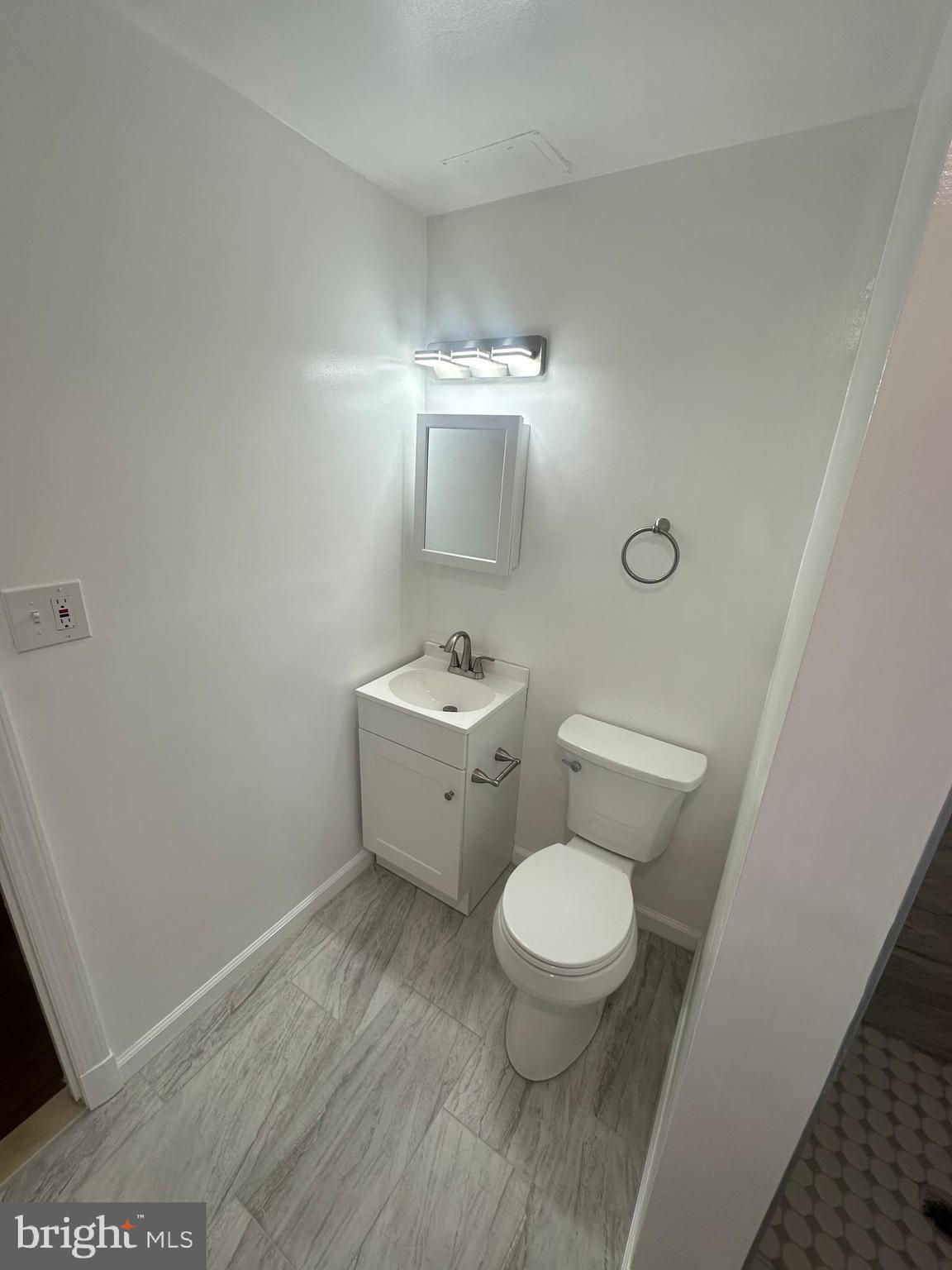 3912 21st Avenue Temple Hills, MD 20748 - Photo 31 of 36 a bathroom with a toilet a sink and mirror