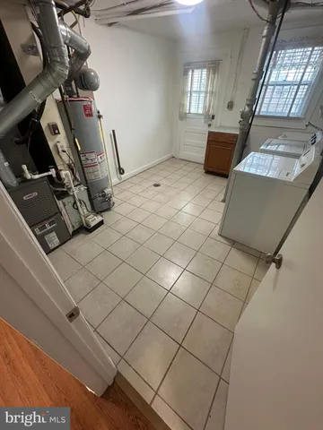 a view of a storage & utility room with two washing machine