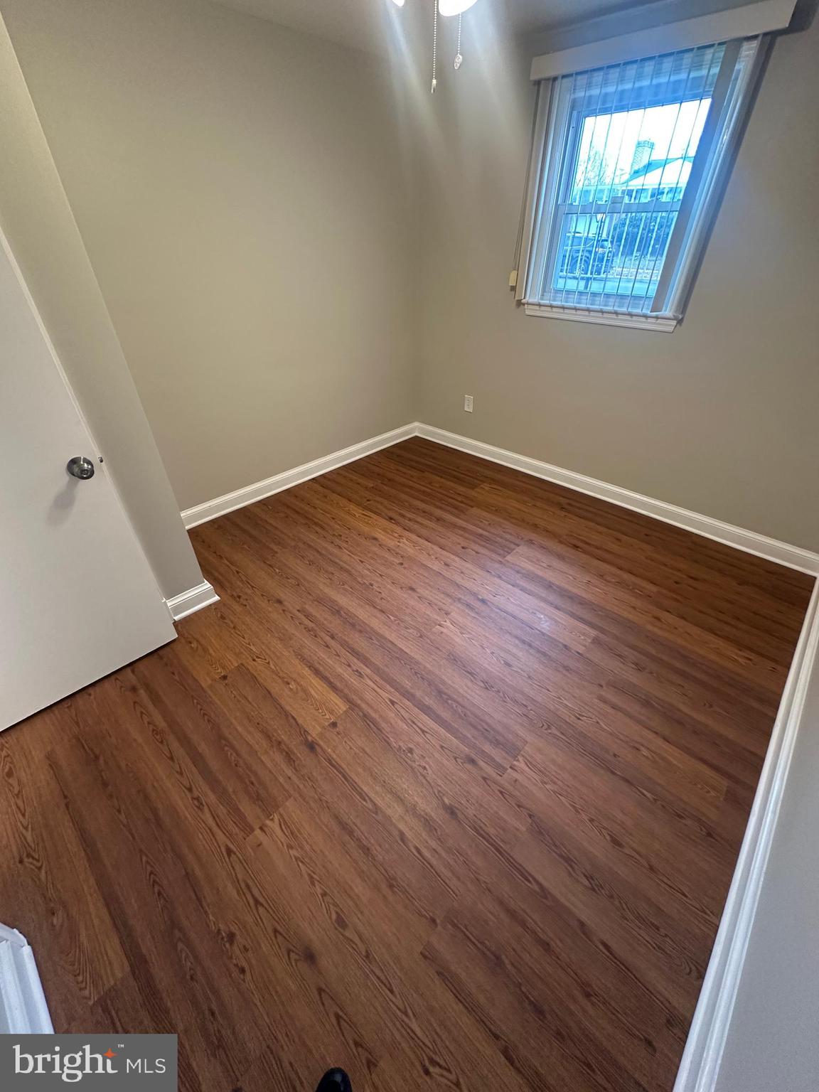 3912 21st Avenue Temple Hills, MD 20748 - Photo 34 of 36 an empty room with wooden floor and windows