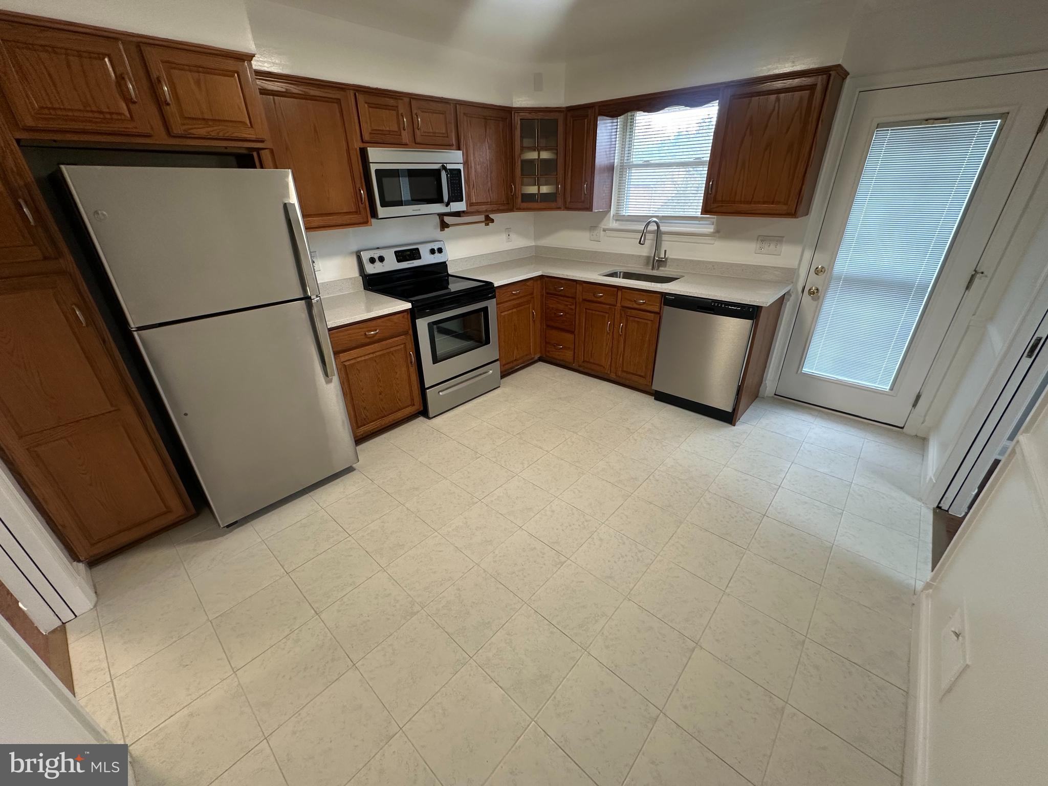 3912 21st Avenue Temple Hills, MD 20748 - Photo 5 of 36 a kitchen with stainless steel appliances granite countertop a refrigerator stove top oven a sink and dishwasher