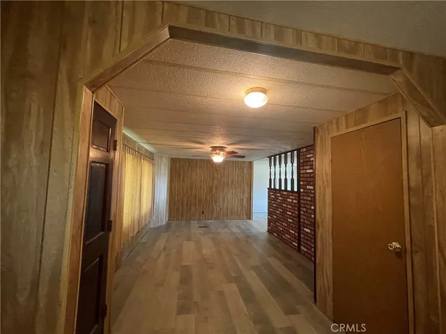 a view of hallway with stairs and wooden floor