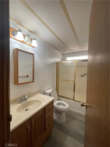 a bathroom with a sink mirror vanity and toilet