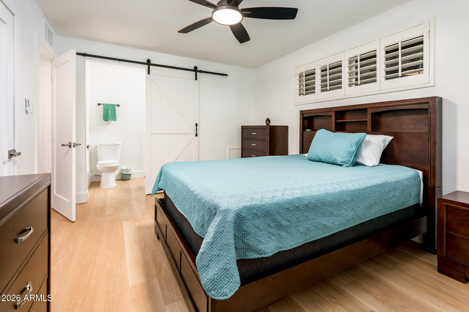 4112 6th Avenue Northwest Phoenix, AZ 85013 - Photo 15 of 23 a spacious bedroom with a bed and a chandelier