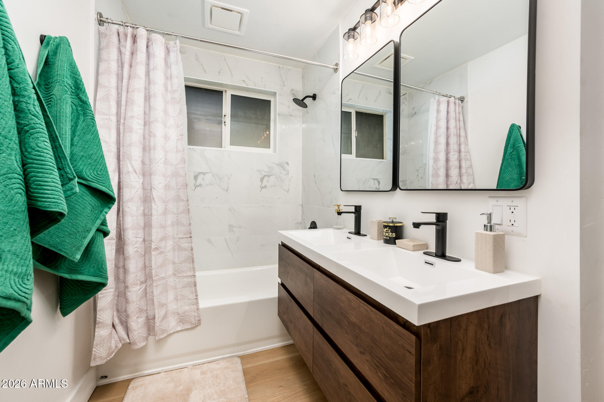4112 6th Avenue Northwest Phoenix, AZ 85013 - Photo 16 of 23 a bathroom with a sink a mirror and a shower