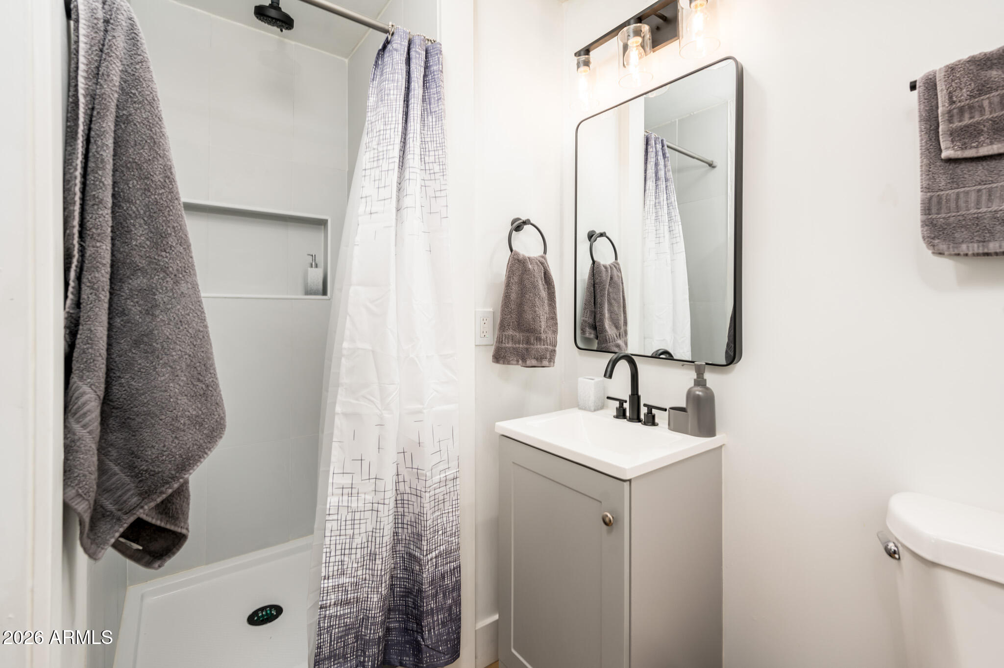 4112 6th Avenue Northwest Phoenix, AZ 85013 - Photo 20 of 23 a bathroom with a sink and mirror