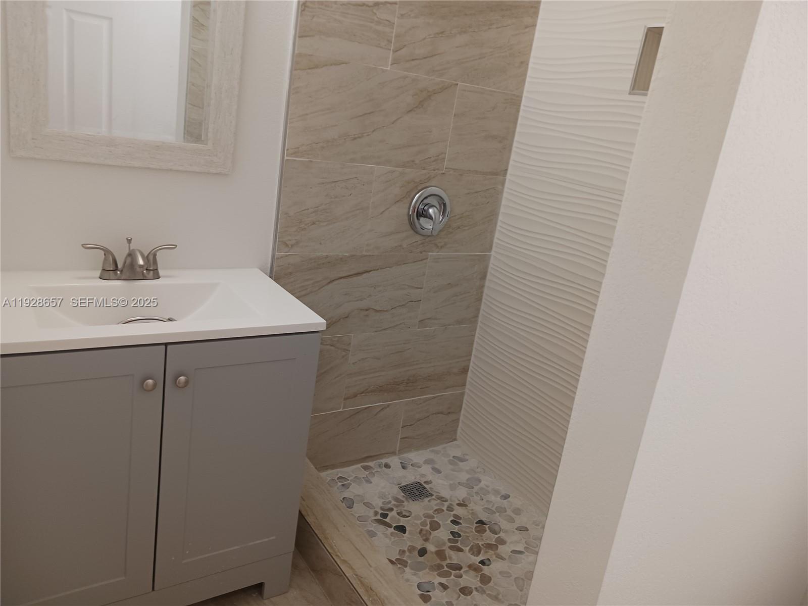 650 Southwest 44th Court Miami, FL 33134 - Photo 2 of 12 a bathroom with a sink and a mirror