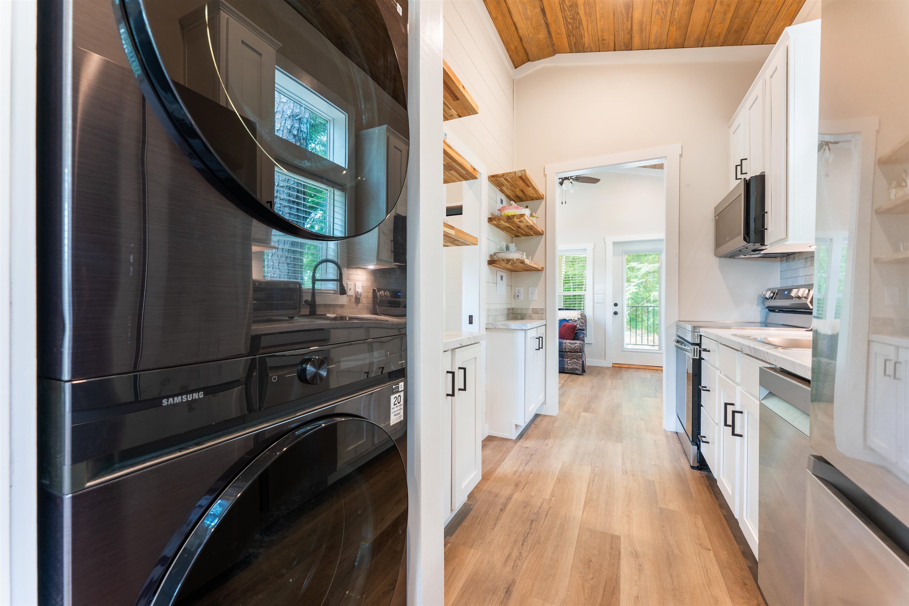 330 Whitley Road Oakland, TN 38060 - Photo 13 of 19 Galley kitchen featuring white cabinetry, light-tone wood-finish flooring, stainless steel appliances, and a vaulted ceiling with wood paneling