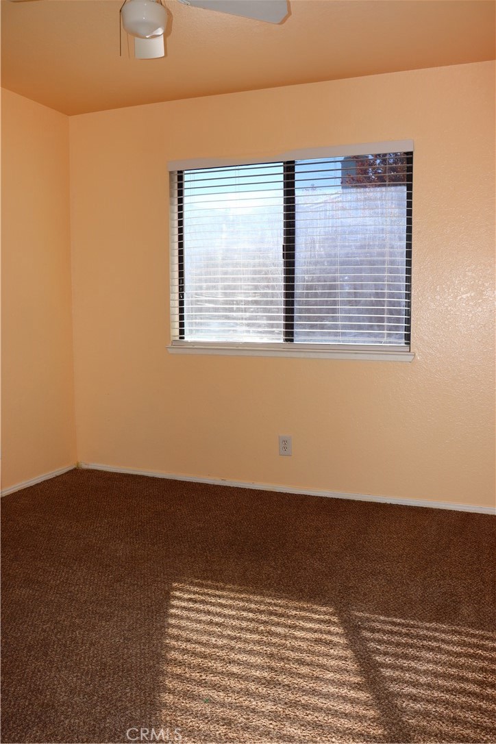 3840 Sago Street Lancaster, CA 93536 - Photo 15 of 23 a view of an empty room with wooden floor and a window