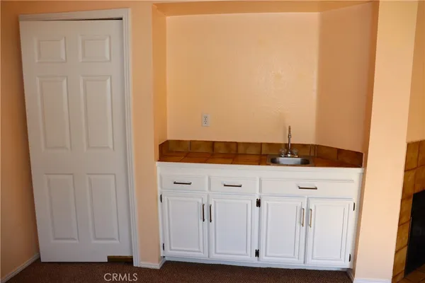 a view of bathroom with granite countertop cabinets