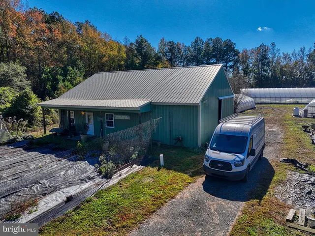 a front view of a house with garden and seating space