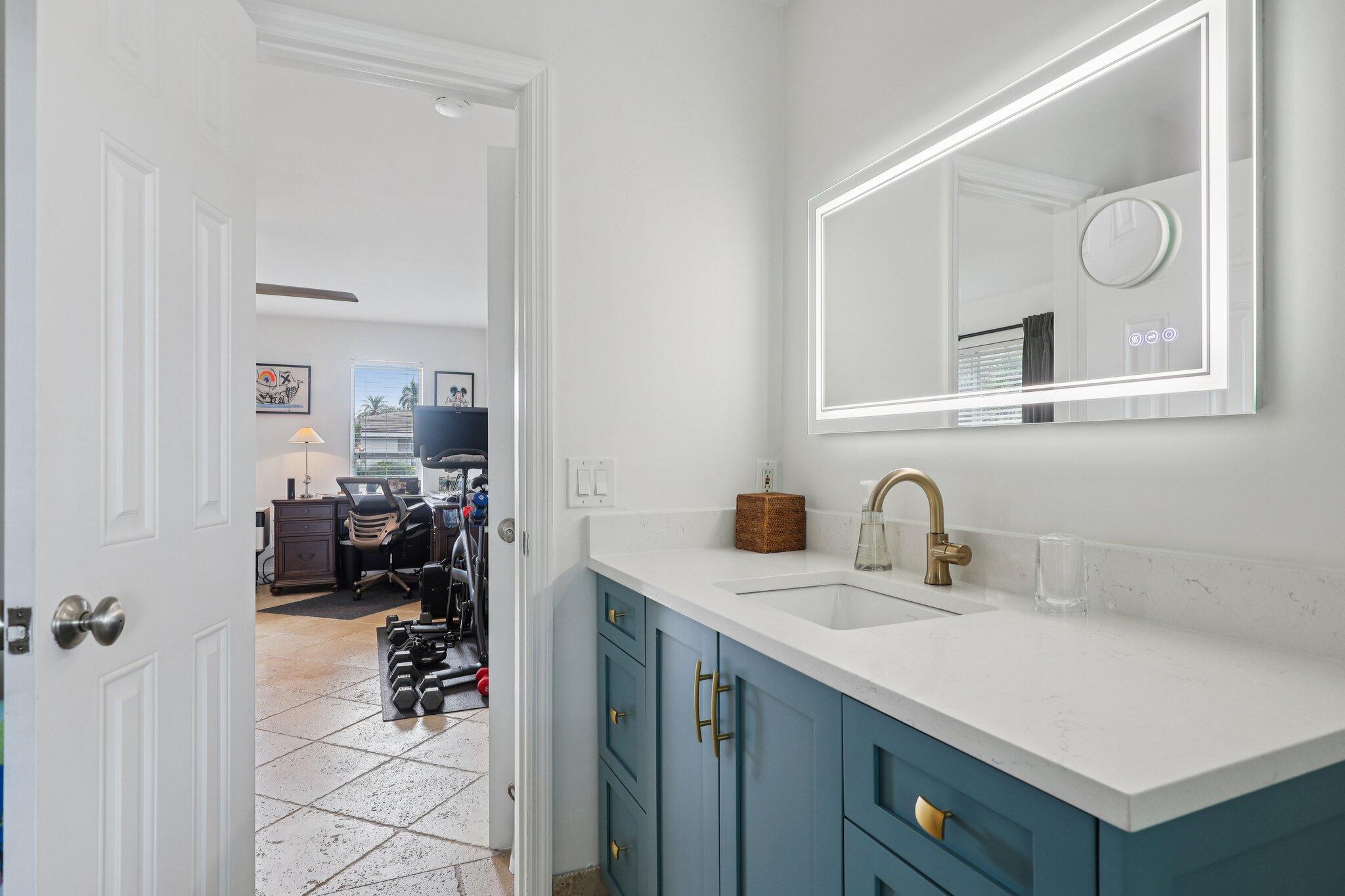 2731 Northeast 5th Street Pompano Beach, FL 33062 - Photo 25 of 91 a bathroom with a sink and a mirror