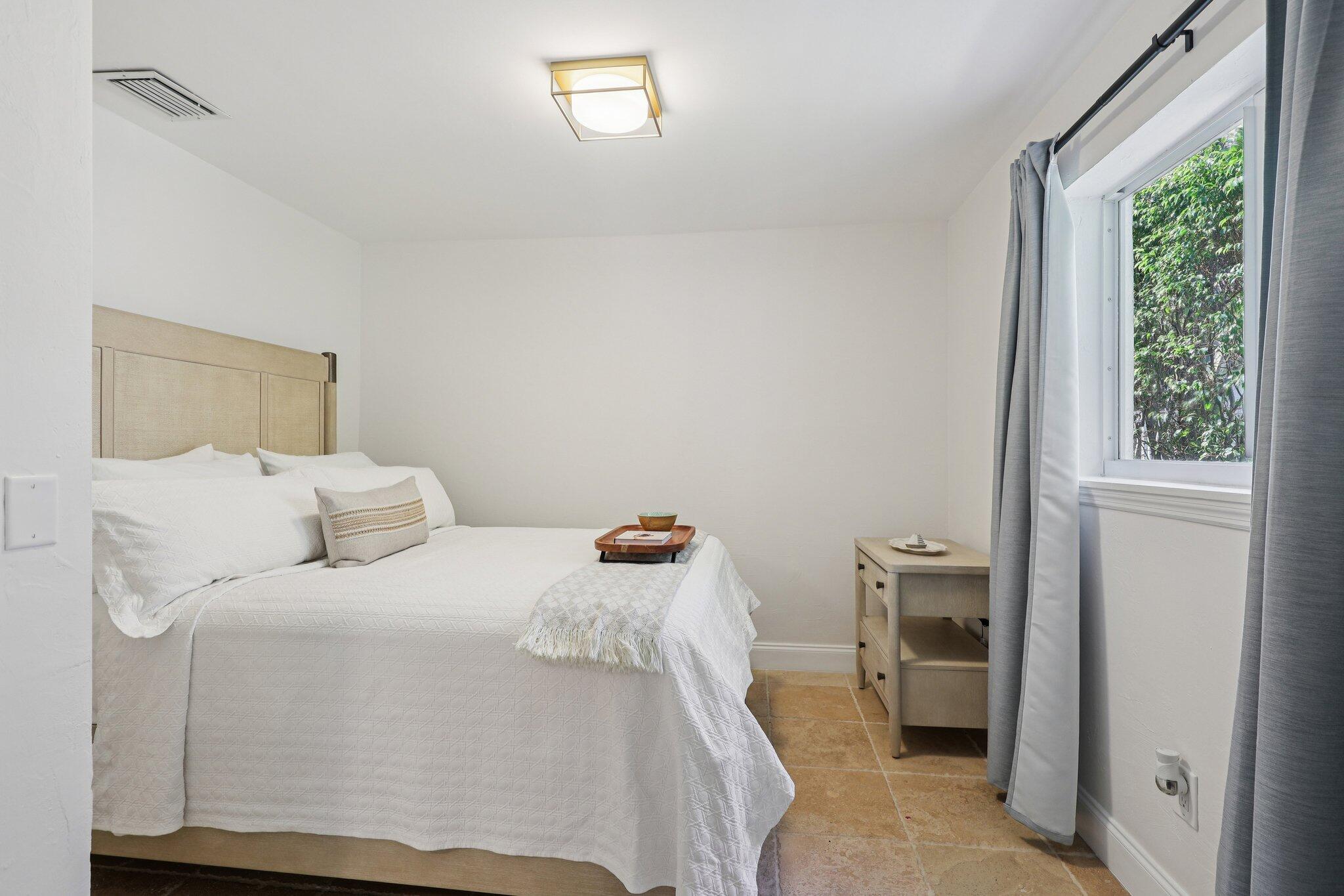 2731 Northeast 5th Street Pompano Beach, FL 33062 - Photo 27 of 91 a bedroom with a bed and a window