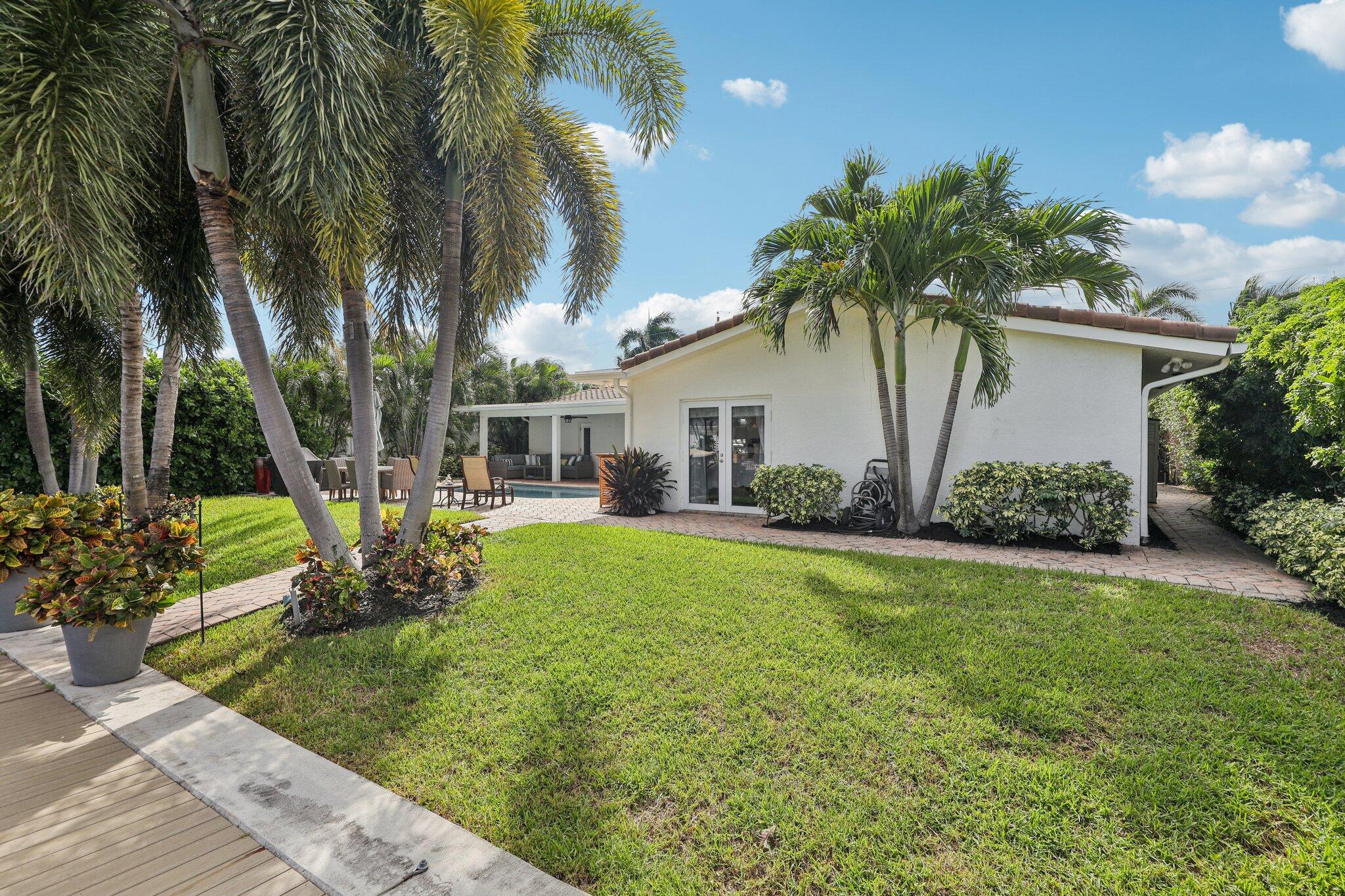 2731 Northeast 5th Street Pompano Beach, FL 33062 - Photo 46 of 91 a front view of a house with garden