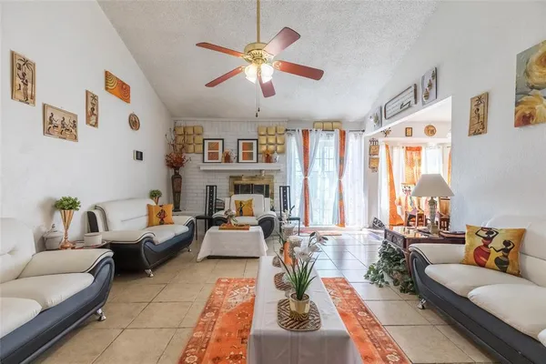 a living room with furniture fireplace and a large window