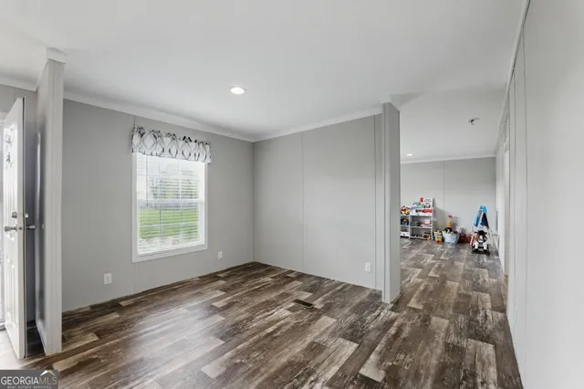 a view of a room with window and hardwood floor