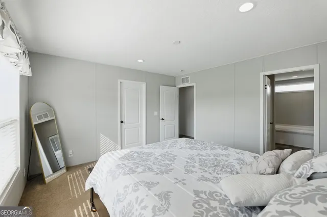a bathroom with a granite countertop sink and toilet