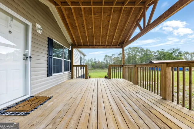 a view of a balcony with wooden floor and city view