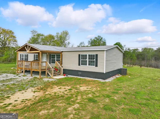 a view of a house with backyard sitting area and garden