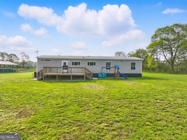 an aerial view of residential houses with outdoor space and city view