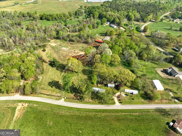 a view of a grassy field with trees