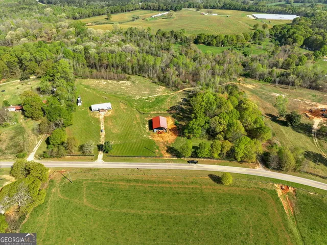 a view of a yard with swimming pool and trees