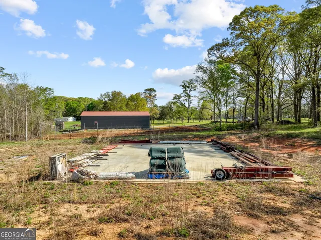 a view of a field with an trees in the background