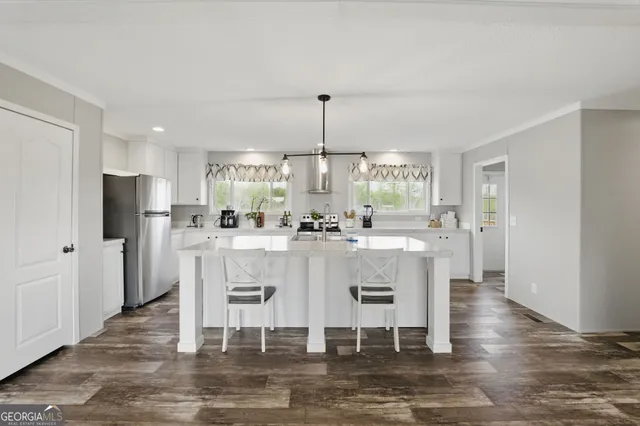 a view of a kitchen with dining table and chairs