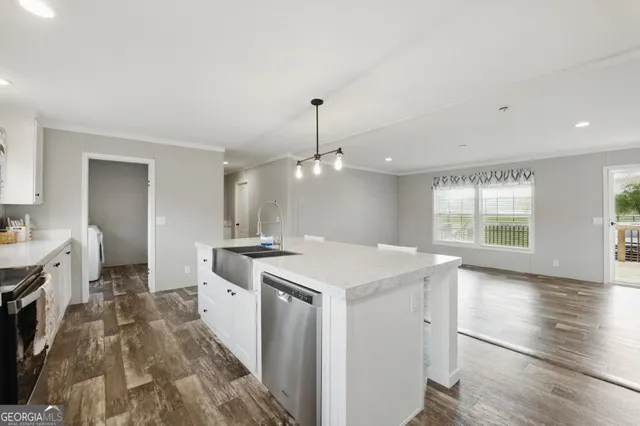 a kitchen with a stove a sink and a refrigerator