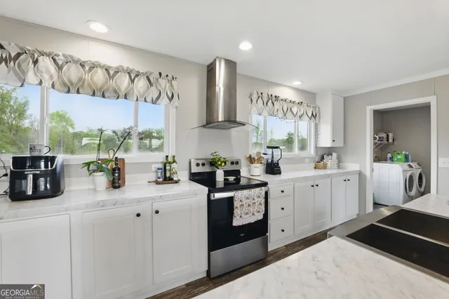 a kitchen with lot of cabinets and window