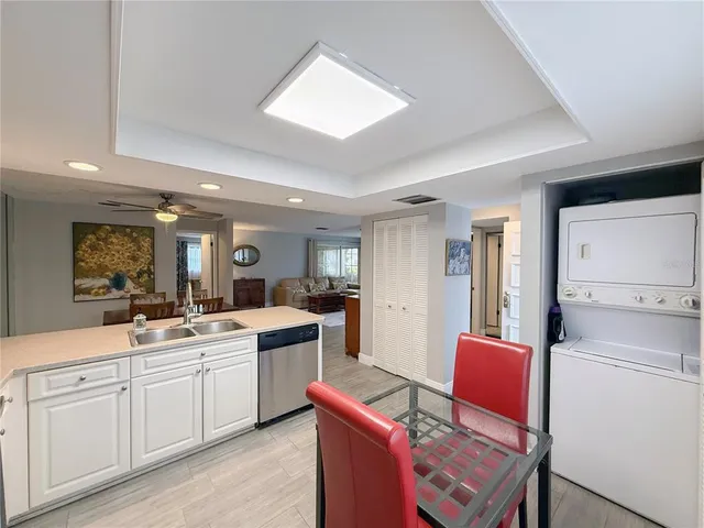 a kitchen that has a sink a stove counter top space and cabinets