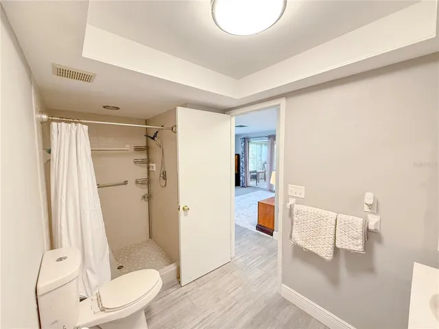 a bathroom with a shower and a toilet
