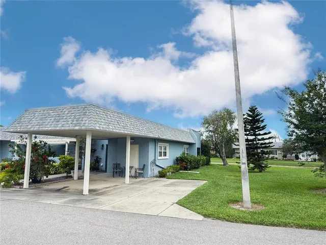 a view of a house with a yard and plants