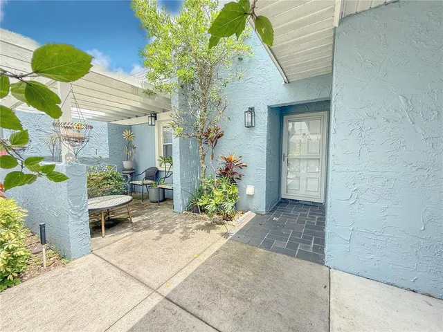 a view of a house with potted plants