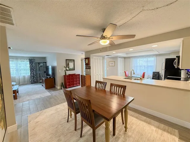 a view of a dining room with furniture and a chandelier