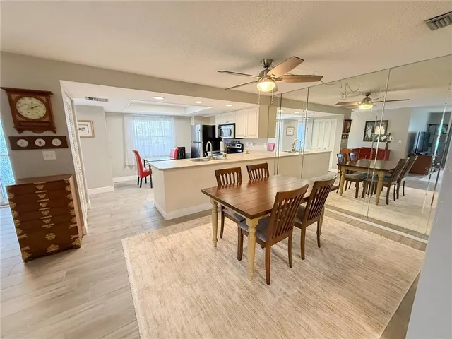 a view of a dining room with furniture and wooden floor