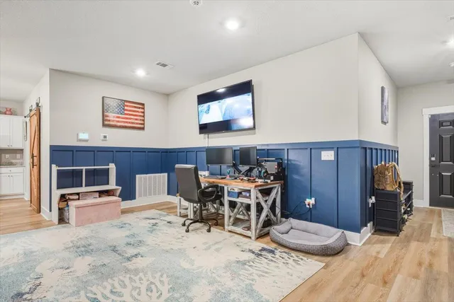 a living room with furniture a dining table and chairs with kitchen view