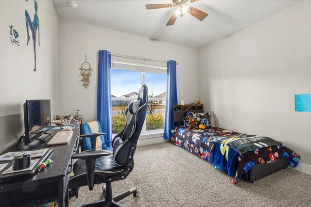 a bedroom with bed and a chandelier
