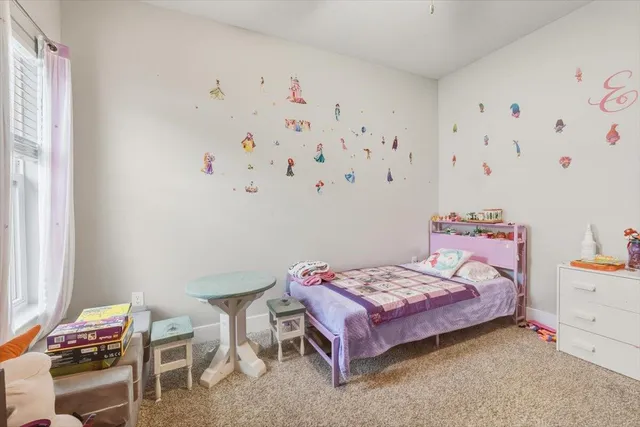 a bedroom with a bed and a table in it