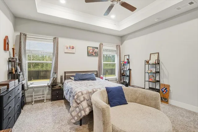 a bedroom with a large bed and a window