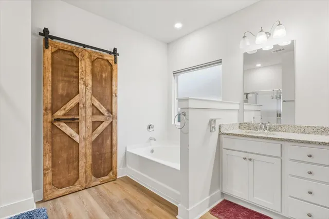 a bathroom with a sink a mirror and a shower