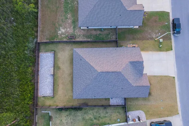 an aerial view of a house with a yard