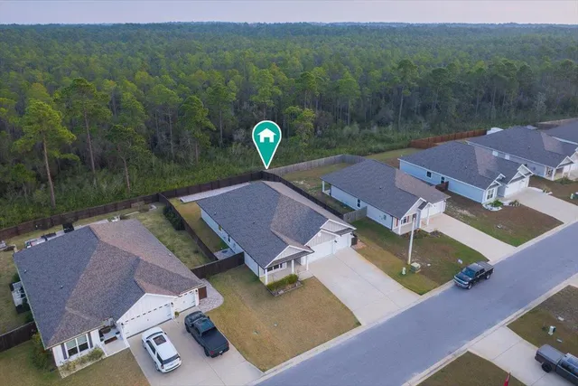 an aerial view of a house with pool