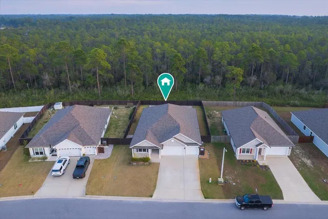 an aerial view of a house with pool