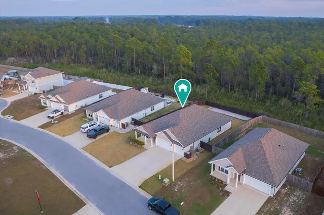 an aerial view of a house with pool